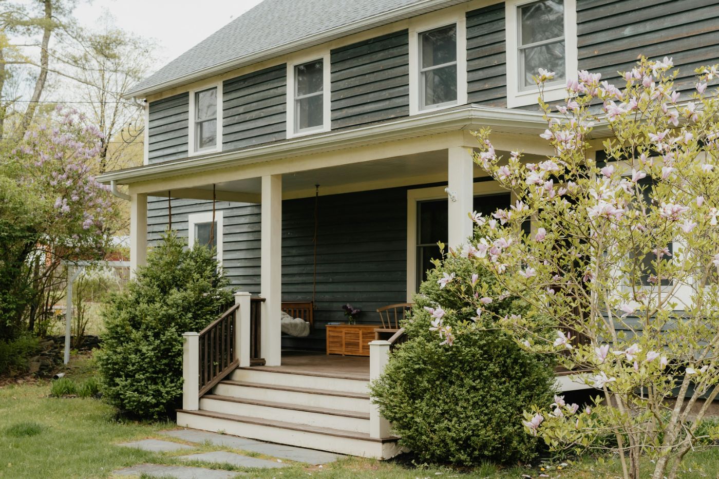 Front porch and steps of a two-story home in spring, illustrating a family court judgment lien on real estate