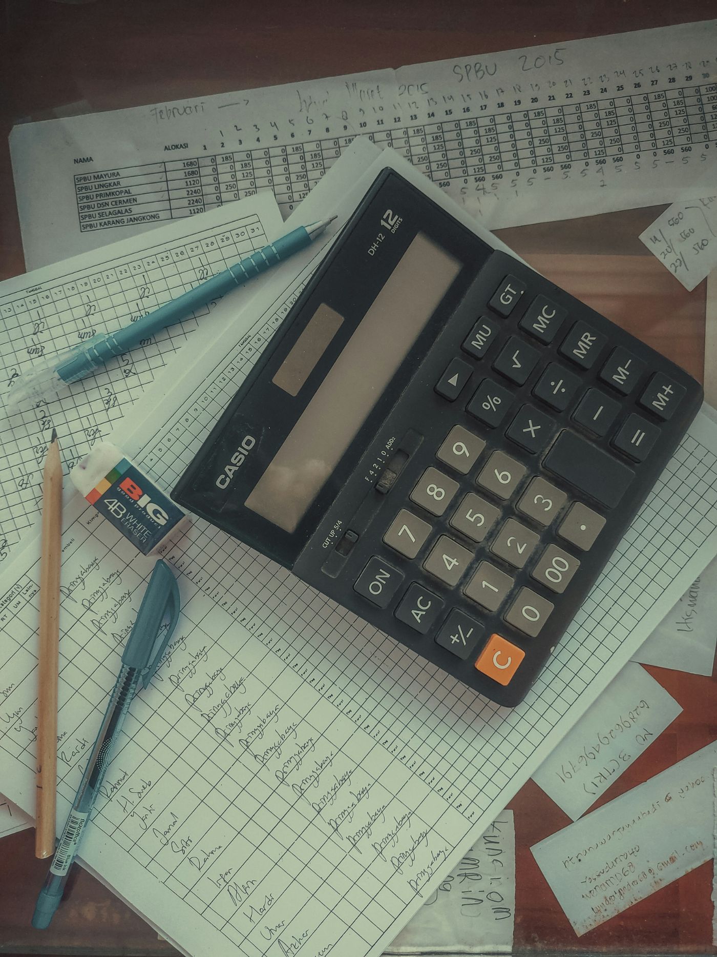 Credit card statements and a calculator on a table, representing marital debt in a South Carolina divorce.