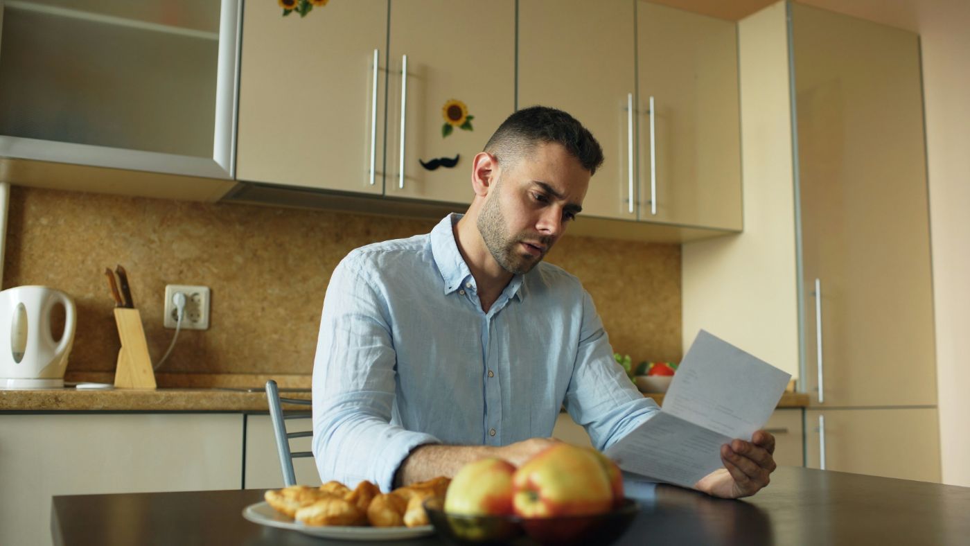 A person reviewing accident paperwork at a kitchen table, asking do I have a personal injury case.