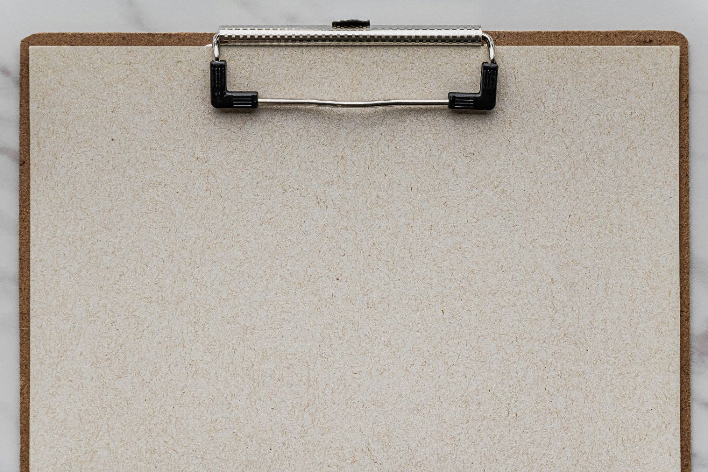 A blank sheet held on a clipboard against a marble surface, illustrating a liability waiver and assumption of risk in South Carolina