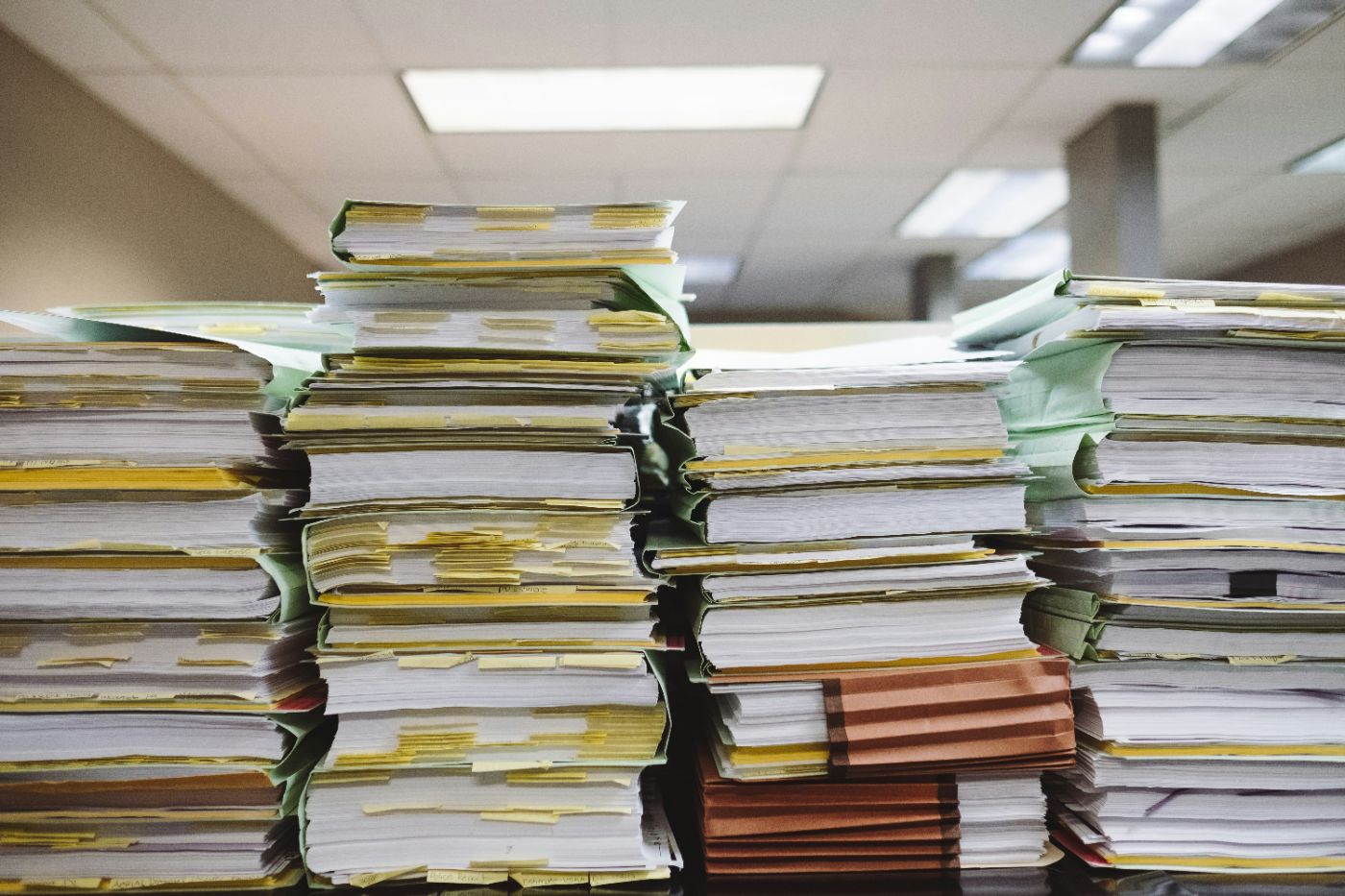 Tall stacks of tabbed case files and folders on an office desk, representing the affidavits and exhibits behind a temporary hearing in South Carolina family court