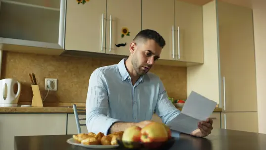 Man looking at piece of paper
