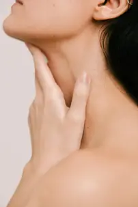 Person touching their neck