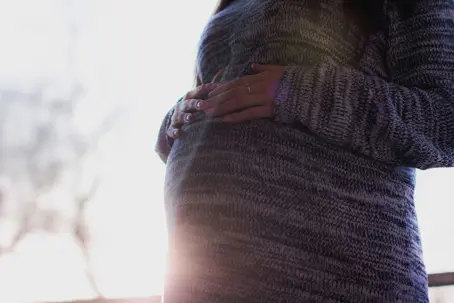 Pregnant women holding her belly