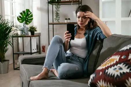 Women looking on her phone worried