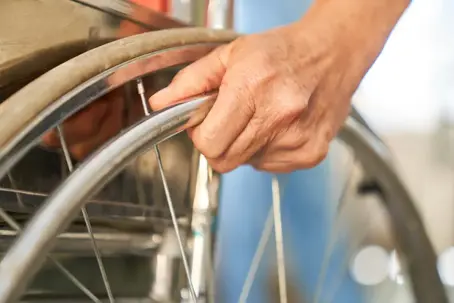 a close up of someone pushing a wheel chair