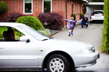 Child running to dad outside of house