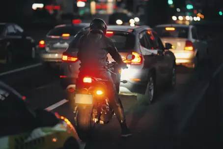 a person on a motorcycle in traffic.