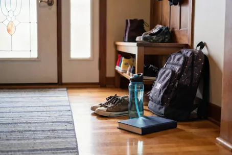 School backpack waiting at front door