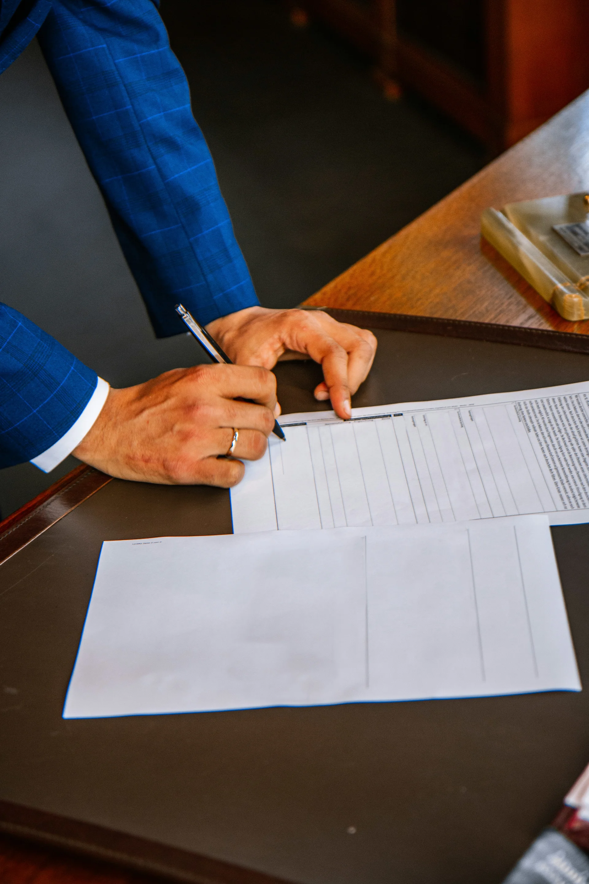 A signed fee agreement and a pen on a desk, representing a contingency fee in South Carolina.